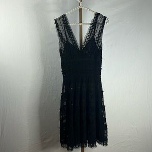 Tight top, more flowy bottom. Lace overlay m, sequin throughout! Classy cocktail